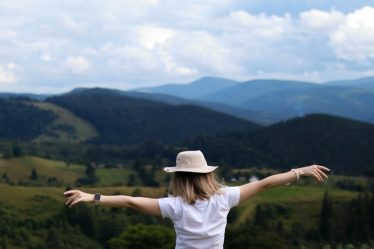 Happy woman high in the mountains