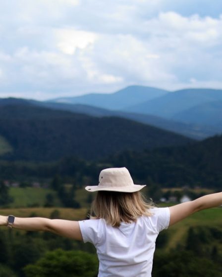 Happy woman high in the mountains