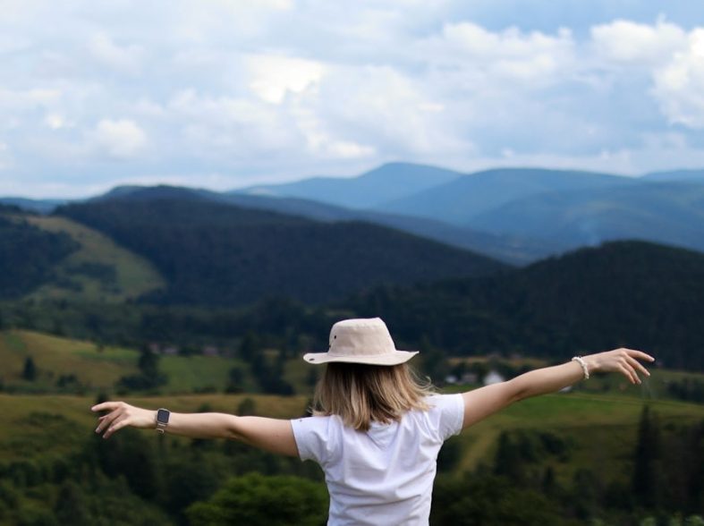 Happy woman high in the mountains